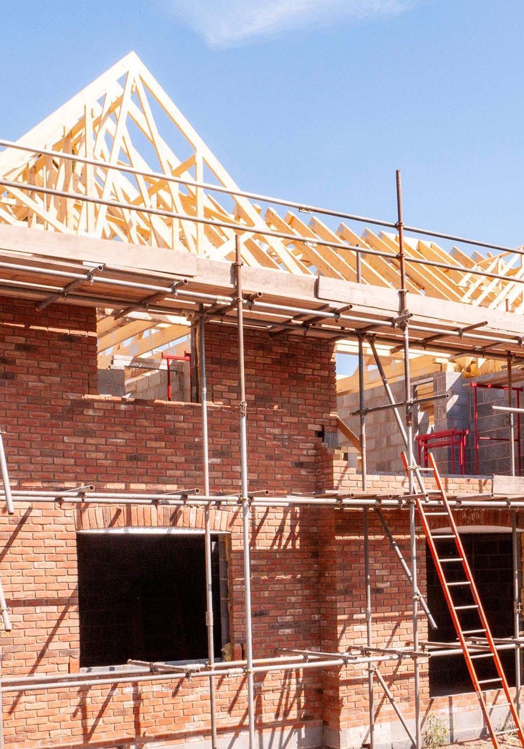 Large house in process of getting built with timber roof exposed